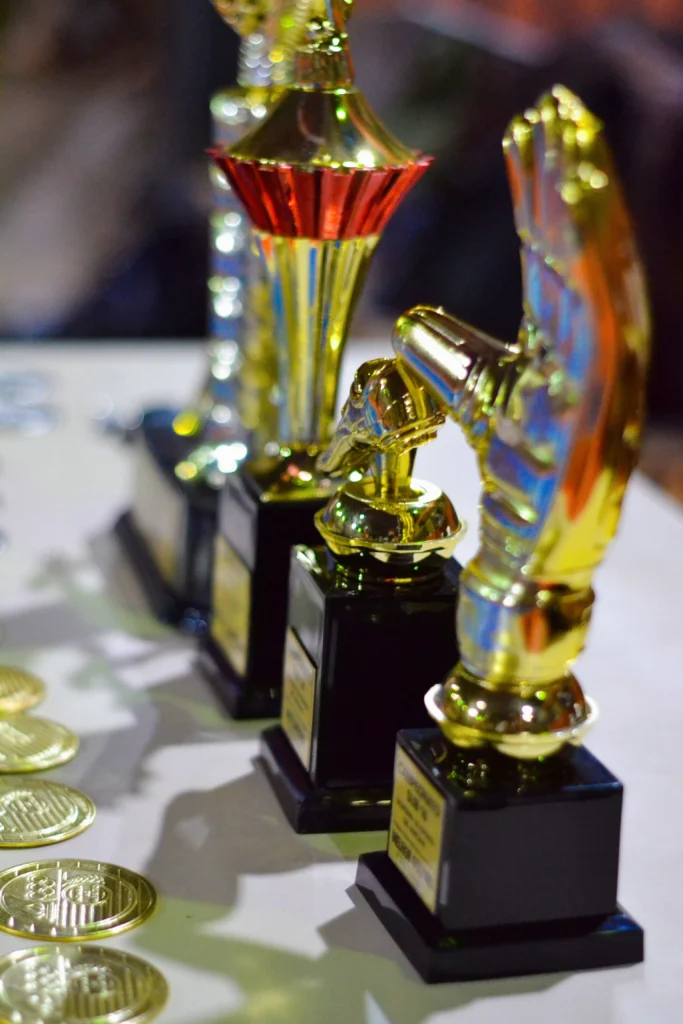 Golden trophies lined up for an award ceremony