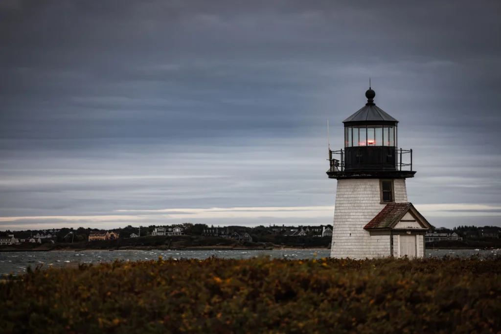 Scenic view of Brant Point Lighthouse with cloudy sky in Nantucket, Massachusetts.