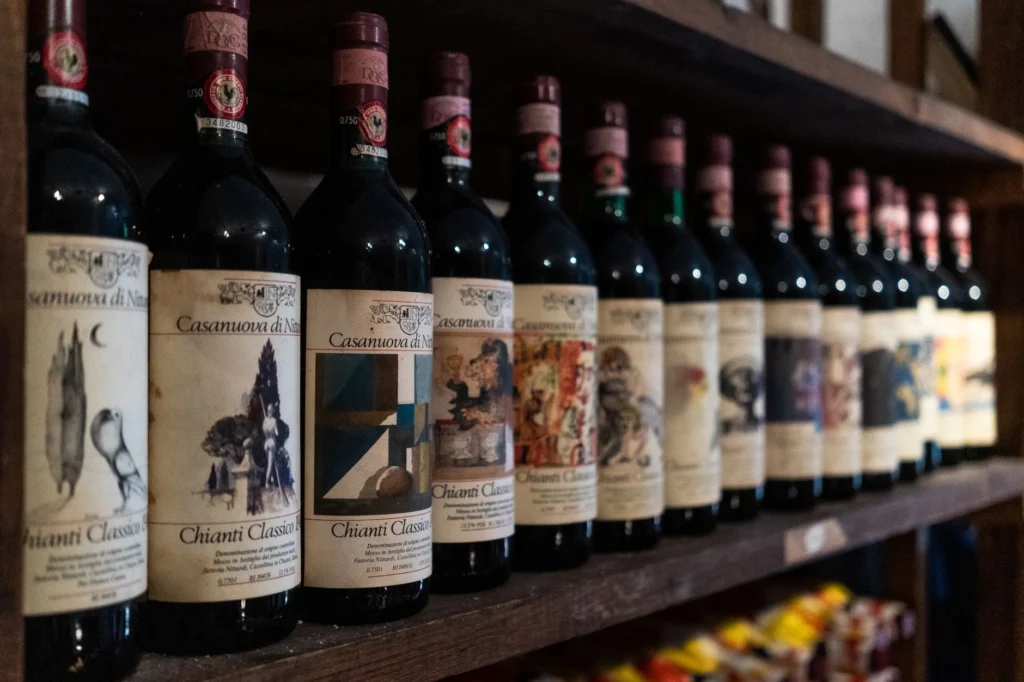 A close-up of Chianti Classico wine bottles neatly arranged on a cellar shelf in Florence, Italy.