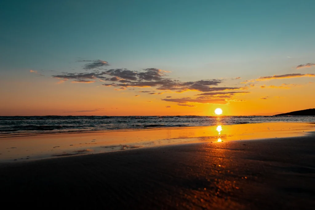 Beautiful sunset reflecting over the tranquil sea at Ulcinj beach, Montenegro, with vibrant colors and serene atmosphere.
