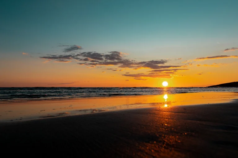 Beautiful sunset reflecting over the tranquil sea at Ulcinj beach, Montenegro, with vibrant colors and serene atmosphere.
