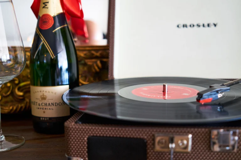 A vintage turntable with vinyl and Moët & Chandon champagne for a classic vibe.