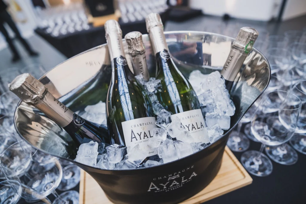 Close-up of champagne bottles in ice bucket at a Paris event, perfect for celebrations.