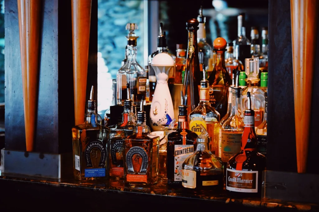 An inviting bar scene showcasing a vibrant assortment of liquor bottles.
