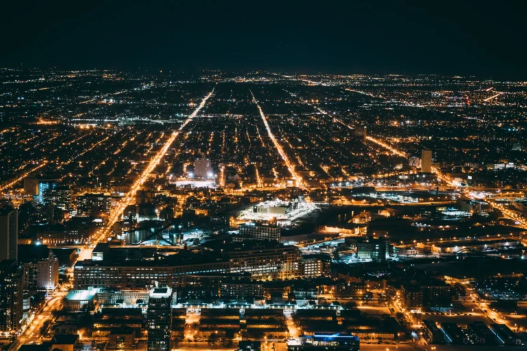 A breathtaking aerial view of a cityscape illuminated at night, showcasing urban beauty and vibrant city lights.