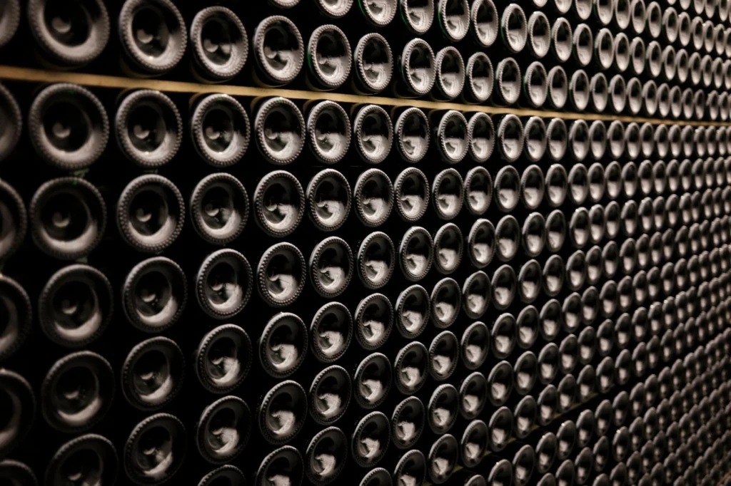 A close-up view of wine bottles stacked symmetrically in a wine cellar in Brussels, Belgium.