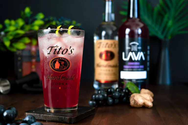 A vibrant Tito's Handmade Vodka cocktail with ginger and berries, perfect for a refreshing evening.