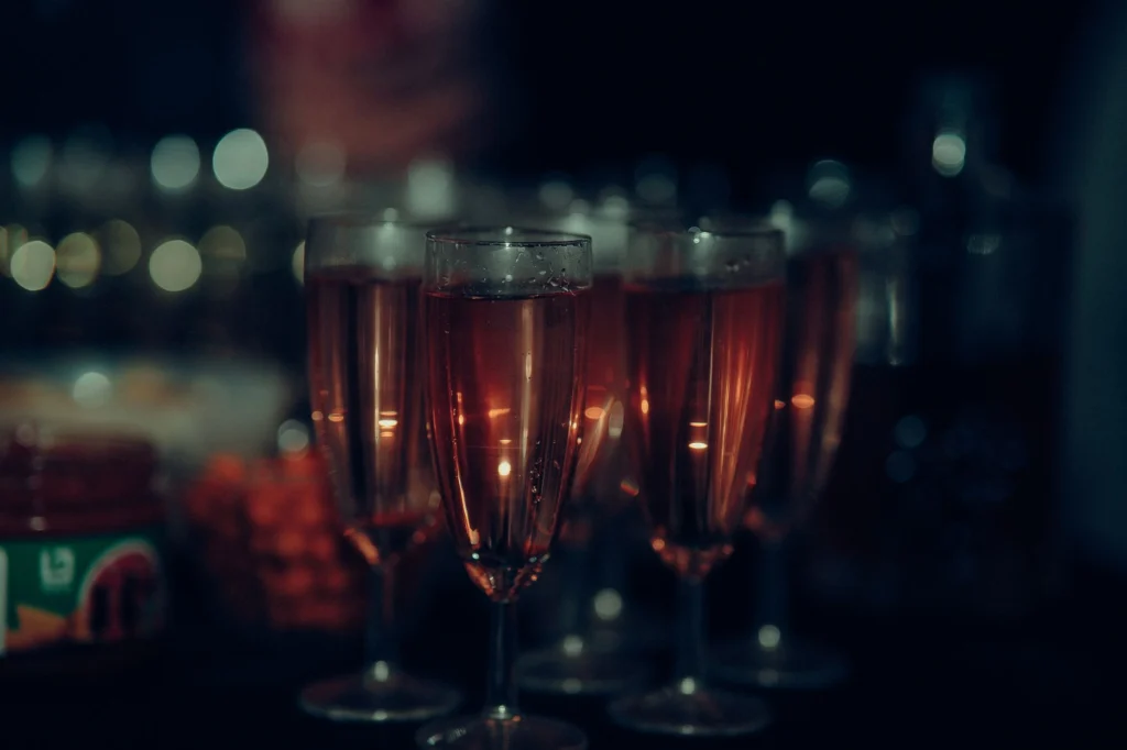Close-up of champagne glasses at a party, capturing a festive atmosphere.