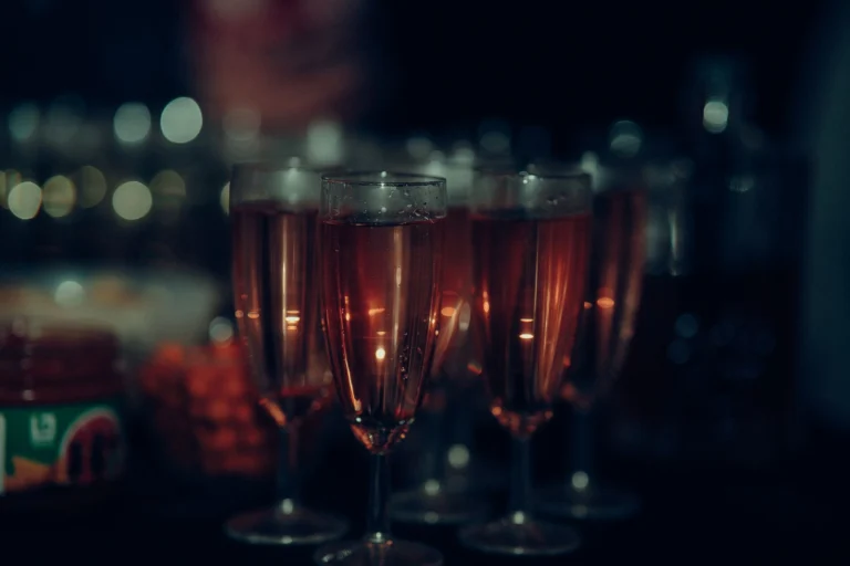 Close-up of champagne glasses at a party, capturing a festive atmosphere.