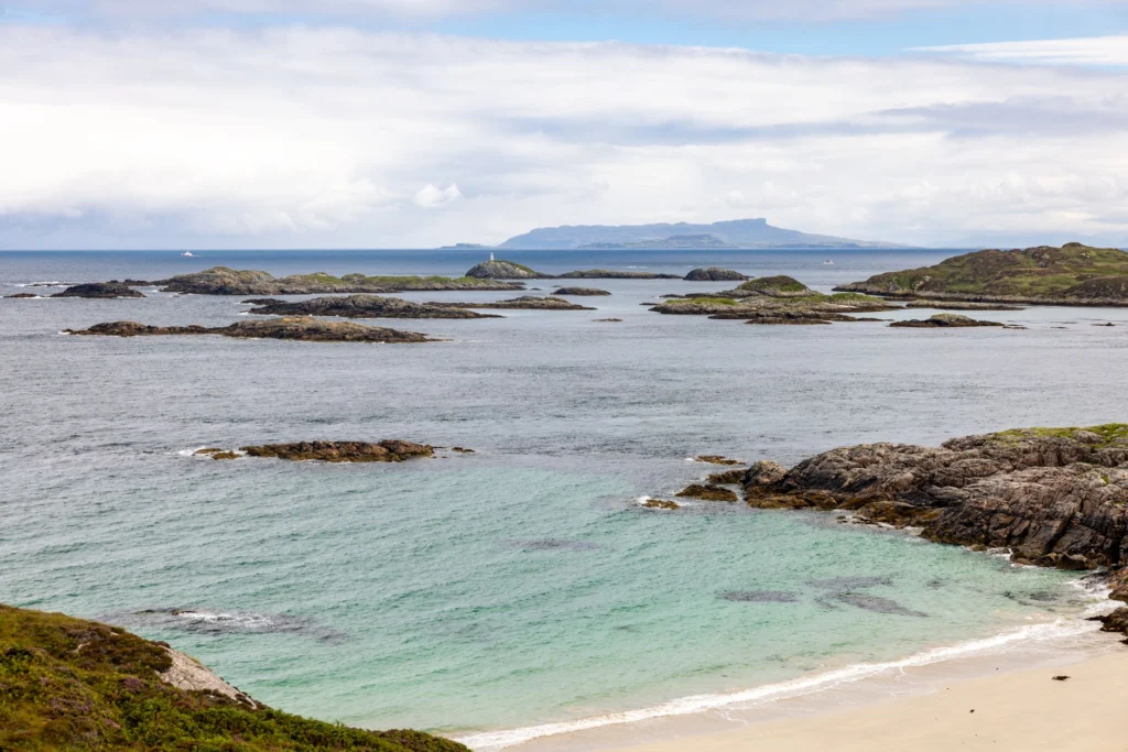 Explore a tranquil coastal scene with rocky islands, turquoise water, and expansive ocean views.