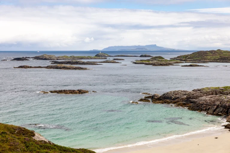 Explore a tranquil coastal scene with rocky islands, turquoise water, and expansive ocean views.