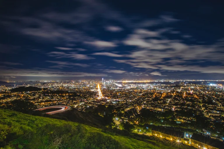 Breathtaking long-exposure night shot of San Francisco city lights from an elevated viewpoint.