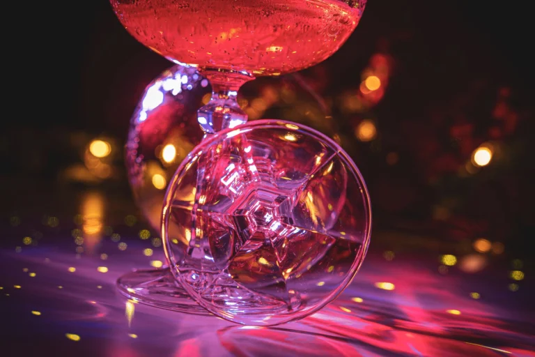 Vibrant champagne flutes with disco ball reflections evoke a festive party atmosphere.
