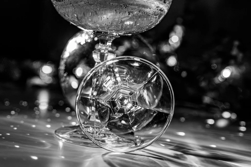 Black and white image of elegant champagne glasses creating a festive, sophisticated mood.