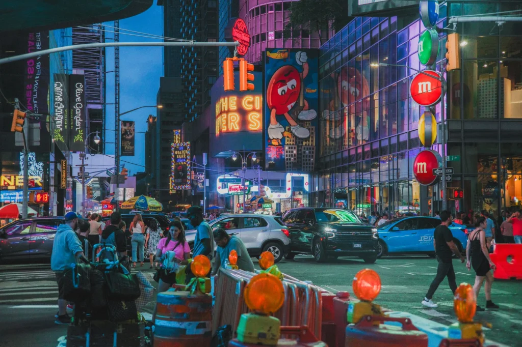 Lively evening in Times Square with neon lights, crowds, and iconic advertisements.