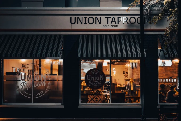 Street view of Union Taproom with warm night lighting and visible patrons inside.