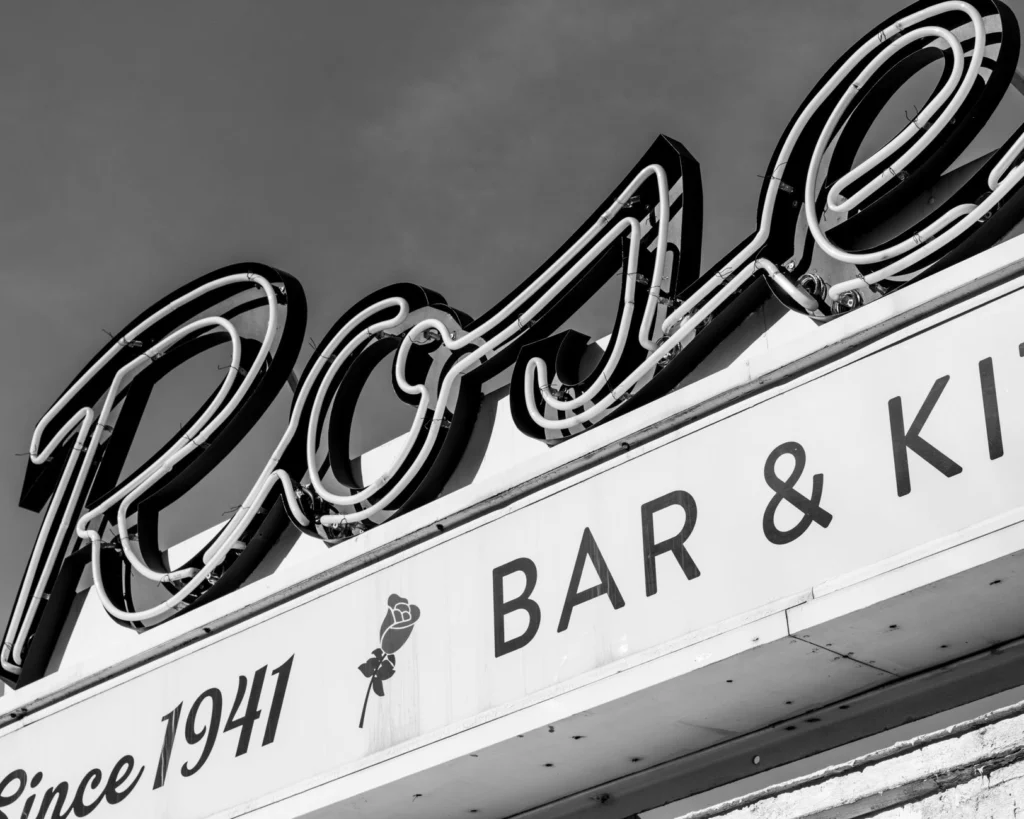 Black and white photo of a historic neon bar sign in Somerville, Massachusetts, since 1941.