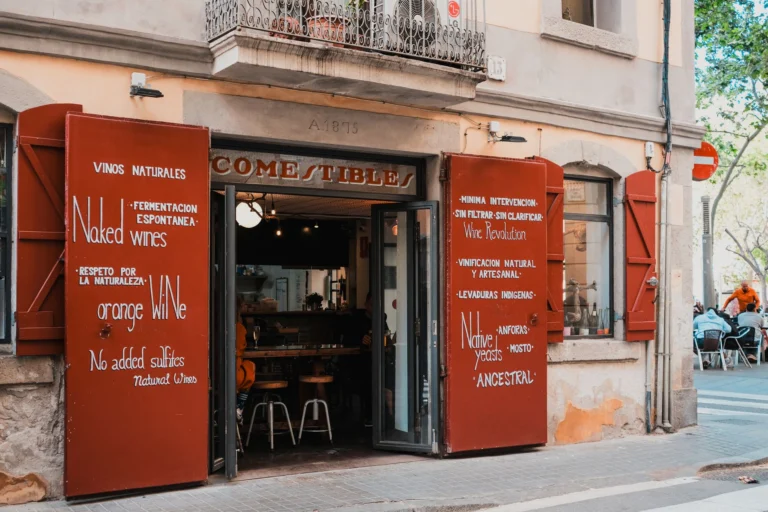 Exterior view of a quaint wine bar in Spain, showcasing its rustic charm and inviting atmosphere.