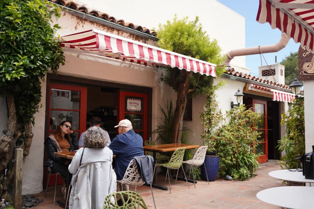 Cozy café with vibrant awnings in Carmel-by-the-Sea, CA. Perfect for relaxing outdoors.