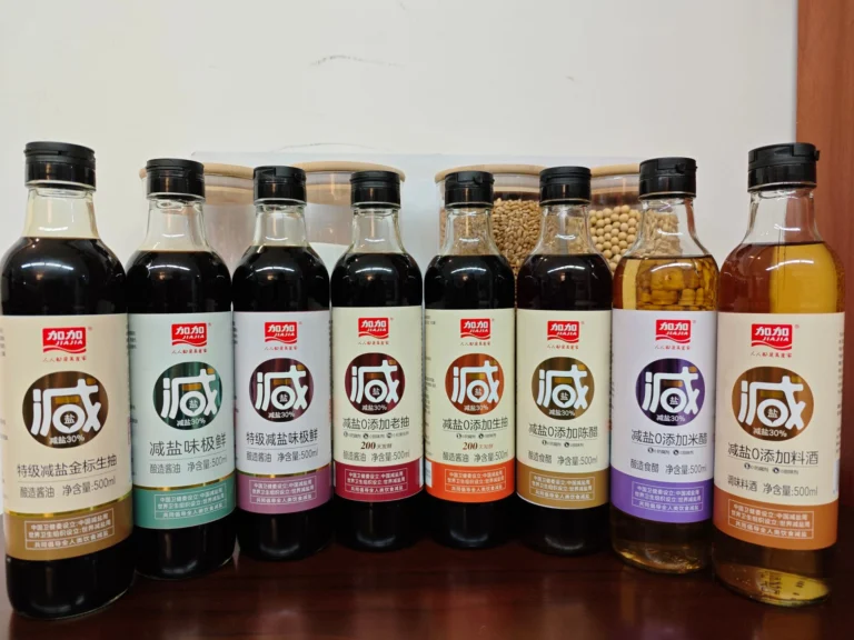 A collection of various flavored soy sauce bottles arranged neatly on a shelf.