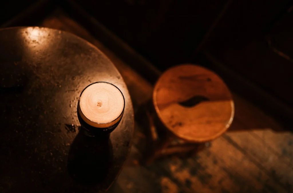 Warm, inviting atmosphere of a rustic cafe in Madrid featuring a freshly poured beverage on a wooden table.