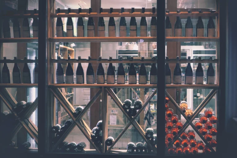 A beautifully arranged wine display in a market setting, featuring diverse bottles.